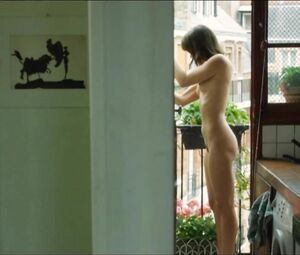 Lewd Vimala Pons is watched by man smoking on balcony in J'aurais Pu être Une Pute