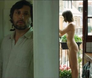 Lewd Vimala Pons is watched by man smoking on balcony in J'aurais Pu être Une Pute