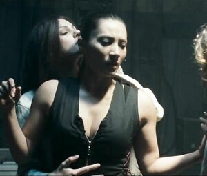 Girl with black hair is attacked by two naked co-stars in Return to House on Haunted Hill